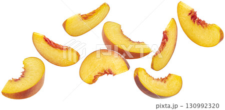 Falling peach slices isolated on white background with clipping path, falling fresh nectarine pieces Falling peach slices isolated on white background with clipping path, falling fresh nectarine pieces 130992320