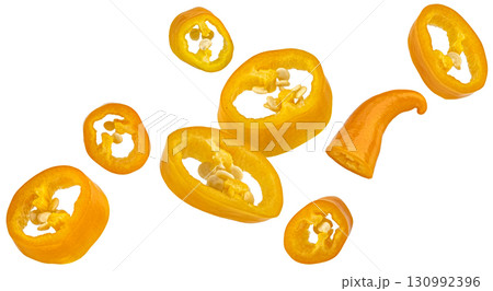 Falling chili pepper slices isolated on white background with clipping path, package design element, full depth of field Falling chili pepper slices isolated on white background with clipping path, package design element, full depth of field 130992396