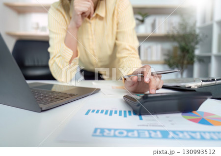 Financial Analysis. Businesswoman calculating data with laptop and calculator. Financial Analysis. Businesswoman calculating data with laptop and calculator. 130993512