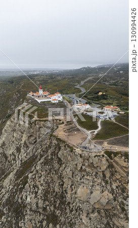 A Beautiful and Breathtaking Aerial View of a Coastal Lighthouse and Surrounding Landscape 130994426