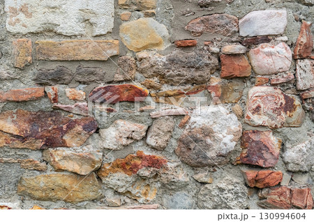 abstract stone background of stones and bricks wall of an old house 130994604