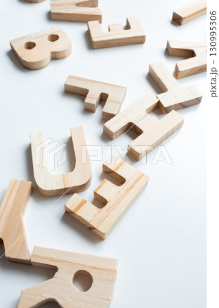 Wooden alphabet blocks on white surface 130995306