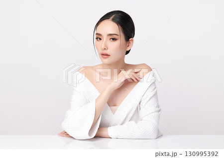 A beautiful young Asian woman with clean, fresh skin against a white background. Skincare, facial treatment, cosmetology, beauty, and spa. An elegant portrait of an Asian woman. A beautiful young Asian woman with clean, fresh skin against a white background. Skincare, facial treatment, cosmetology, beauty, and spa. An elegant portrait of an Asian woman. 130995392