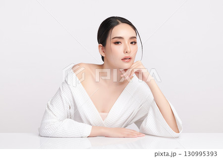 A beautiful young Asian woman with clean, fresh skin against a white background. Skincare, facial treatment, cosmetology, beauty, and spa. An elegant portrait of an Asian woman. A beautiful young Asian woman with clean, fresh skin against a white background. Skincare, facial treatment, cosmetology, beauty, and spa. An elegant portrait of an Asian woman. 130995393