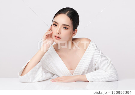 A beautiful young Asian woman with clean, fresh skin against a white background. Skincare, facial treatment, cosmetology, beauty, and spa. An elegant portrait of an Asian woman. A beautiful young Asian woman with clean, fresh skin against a white background. Skincare, facial treatment, cosmetology, beauty, and spa. An elegant portrait of an Asian woman. 130995394