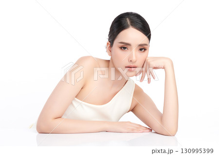 A beautiful young Asian woman with clean, fresh skin against a white background. Skincare, facial treatment, cosmetology, beauty, and spa. An elegant portrait of an Asian woman. A beautiful young Asian woman with clean, fresh skin against a white background. Skincare, facial treatment, cosmetology, beauty, and spa. An elegant portrait of an Asian woman. 130995399