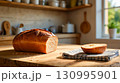 Fresh Homemade Bread on Wooden Cutting Board 130995901