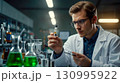 Scientist Conducts Experiment with Chemical Substances 130995922
