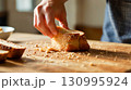 Fresh Homemade Bread on Wooden Cutting Board 130995924