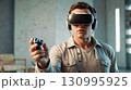 Gamer with Gamepad and VR Headset 130995925