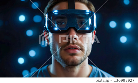 Man in VR Headset Against Glowing Lights 130995927