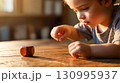 Little Child Playing with Wooden Cube at Home 130995937