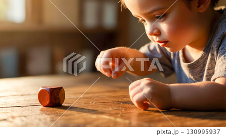 Little Child Playing with Wooden Cube at Home 130995937