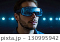 Man in VR Headset Against Glowing Lights 130995942