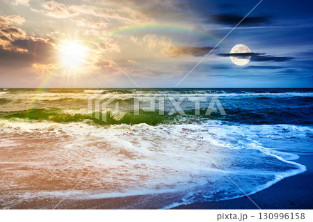 dramatic sea view with overcast sky above horizon. vacation disaster with dark moody atmosphere. day and night time change concept. beauty and danger of nature at the coast in autumn with sun and moon 130996158