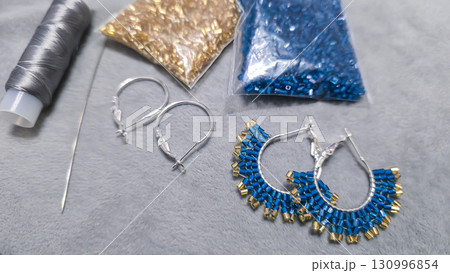 Handmade beaded and glass bead earrings on a light background. Copy space Handmade beaded and glass bead earrings on a light background. Copy space 130996854
