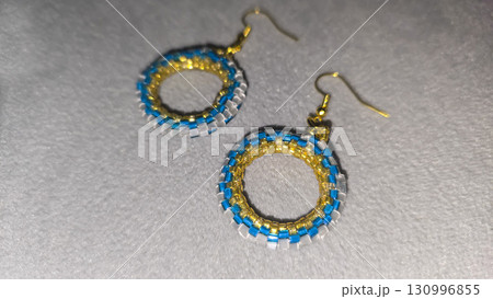 Handmade beaded and glass bead earrings on a light background. Copy space Handmade beaded and glass bead earrings on a light background. Copy space 130996855