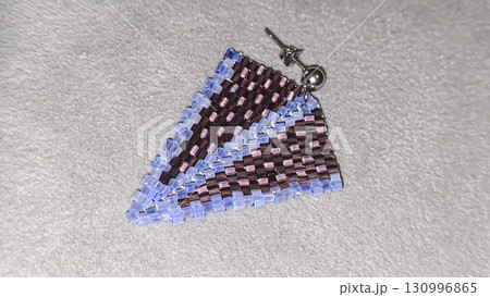Handmade beaded and glass bead earrings on a light background. Copy space 130996865