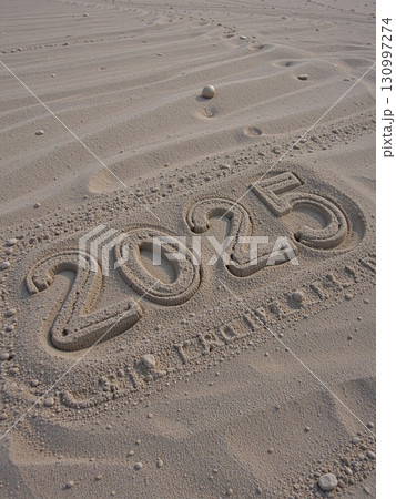 Christmas inscription 2025 on a summer beach. 130997274