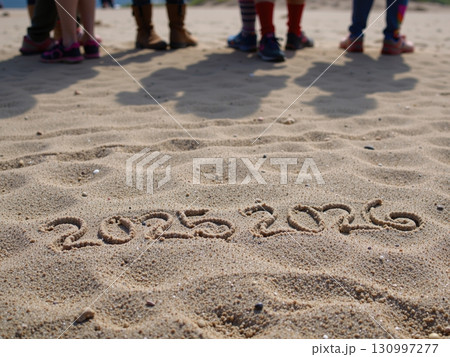 The message Year 2025 has been replaced by the text 2026, written on a beach sand background. 130997277