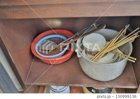 Sept 13 2025 Traditional Kitchen Utensils and Dishware Displayed on Wooden Shelves Indoors 130999136