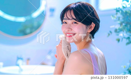 バスルームで顔を洗う若い女性 131000597