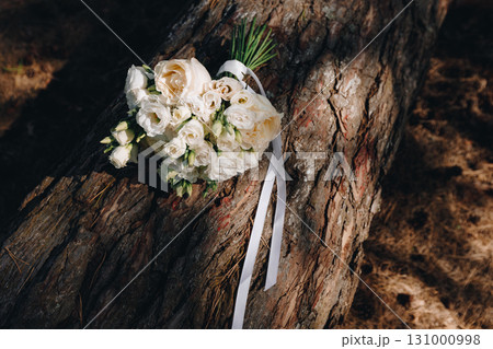 Bridal bouquet with long ribbon outdoors 131000998
