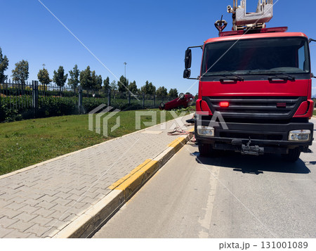 Rescue team of firefighters work on a car crash traffic accident scene. Emergency crew on the car crash scene Rescue team of firefighters work on a car crash traffic accident scene. Emergency crew on the car crash scene 131001089