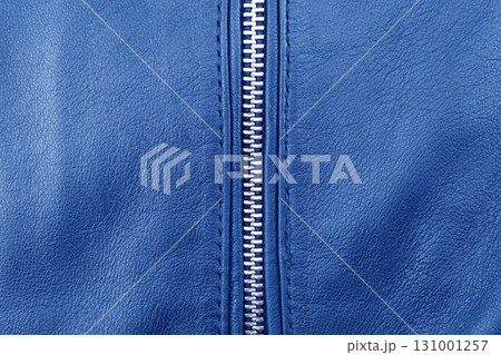 Macro shot of zipper on blue leather texture background with stitching. Close-up of black leather material Macro shot of zipper on blue leather texture background with stitching. Close-up of black leather material 131001257