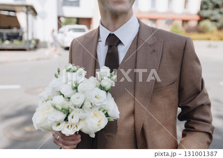 Groom in Suit with Bouquet 131001387