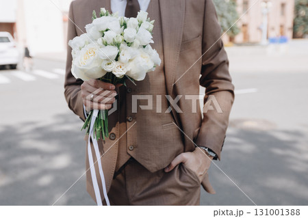 Groom Holding White Bouquet Groom Holding White Bouquet 131001388