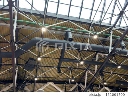Lights and ventilation system in long line on ceiling of the industrial building. Exhibition Hall. Ceiling factory construction. 131001700