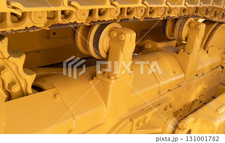 Modern bulldozer tracks and drive gear. Large yellow construction machine. Heavy industry equipment. Equipment for road and construction works 131001782