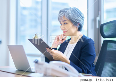 オフィスでデスクワークするシニア ビジネスウーマン 131001934