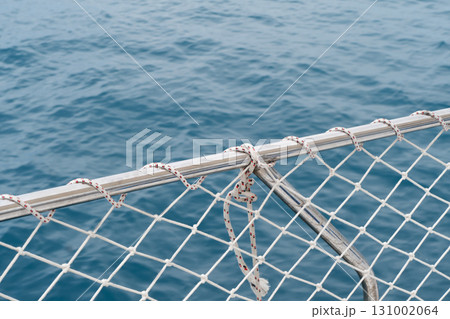 Yacht sailing on clean blue sea surface. Moving boat in the ocean. Side view sailing boat. Ocean sea water wave reflections. Motor boat in the sea. Speedboat in the clear turquoise sea Yacht sailing on clean blue sea surface. Moving boat in the ocean. Side view sailing boat. Ocean sea water wave reflections. Motor boat in the sea. Speedboat in the clear turquoise sea 131002064