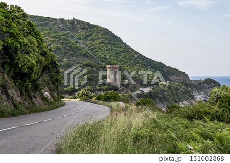 Watchtower view Roadtrip Winding road along rocky coast of Cap Corse peninsula on Corsica island France 131002868