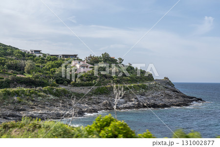 Village beach view Roadtrip Winding road along rocky coast of Cap Corse peninsula on Corsica island France 131002877