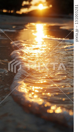 Sunset on the beach with wave and sun reflection in the water 131003281