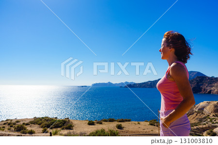 Woman enjoy sea breeze. 131003810