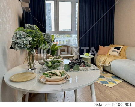 Stylish modern interior, serving of the dining table with appliances and dishes at home. High quality photo 131003901