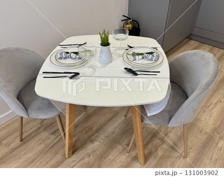 Stylish modern interior, serving of the dining table with appliances and dishes at home. High quality photo 131003902