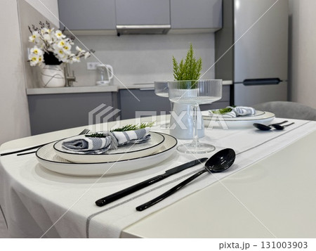 Stylish modern interior, serving of the dining table with appliances and dishes at home. High quality photo 131003903