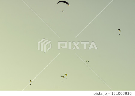 Paragliders flying in sky. Paragliders flying in sky. 131003936