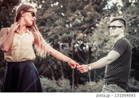 Cheerful girl holding hands in park. Cheerful girl holding hands in park. 131004093
