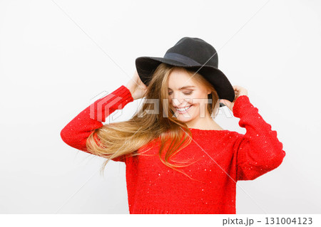 Smiling pretty girl with brown hair and black hat. 131004123