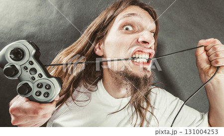 Stressed man playing on pad 131004253