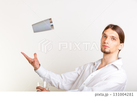 Skilled bartender juggling with glass. 131004281
