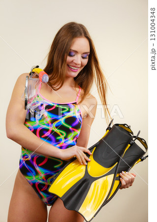 Woman with flippers and snorkeling mask having fun 131004348