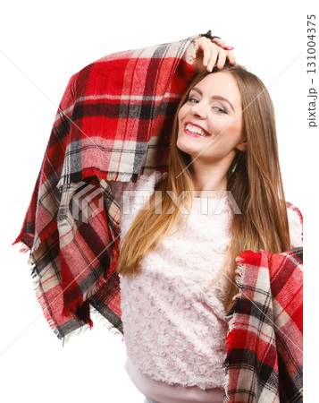 Woman wearing warm scarf warming herself up 131004375