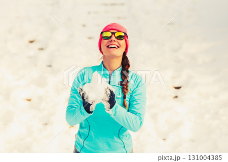 Young female holding snow Young female holding snow 131004385